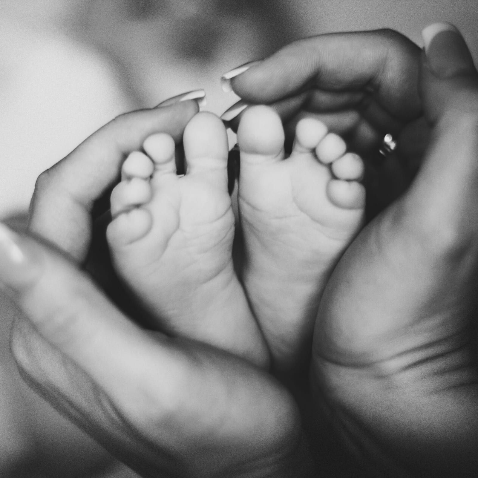 Mother Holding Baby's Feet.