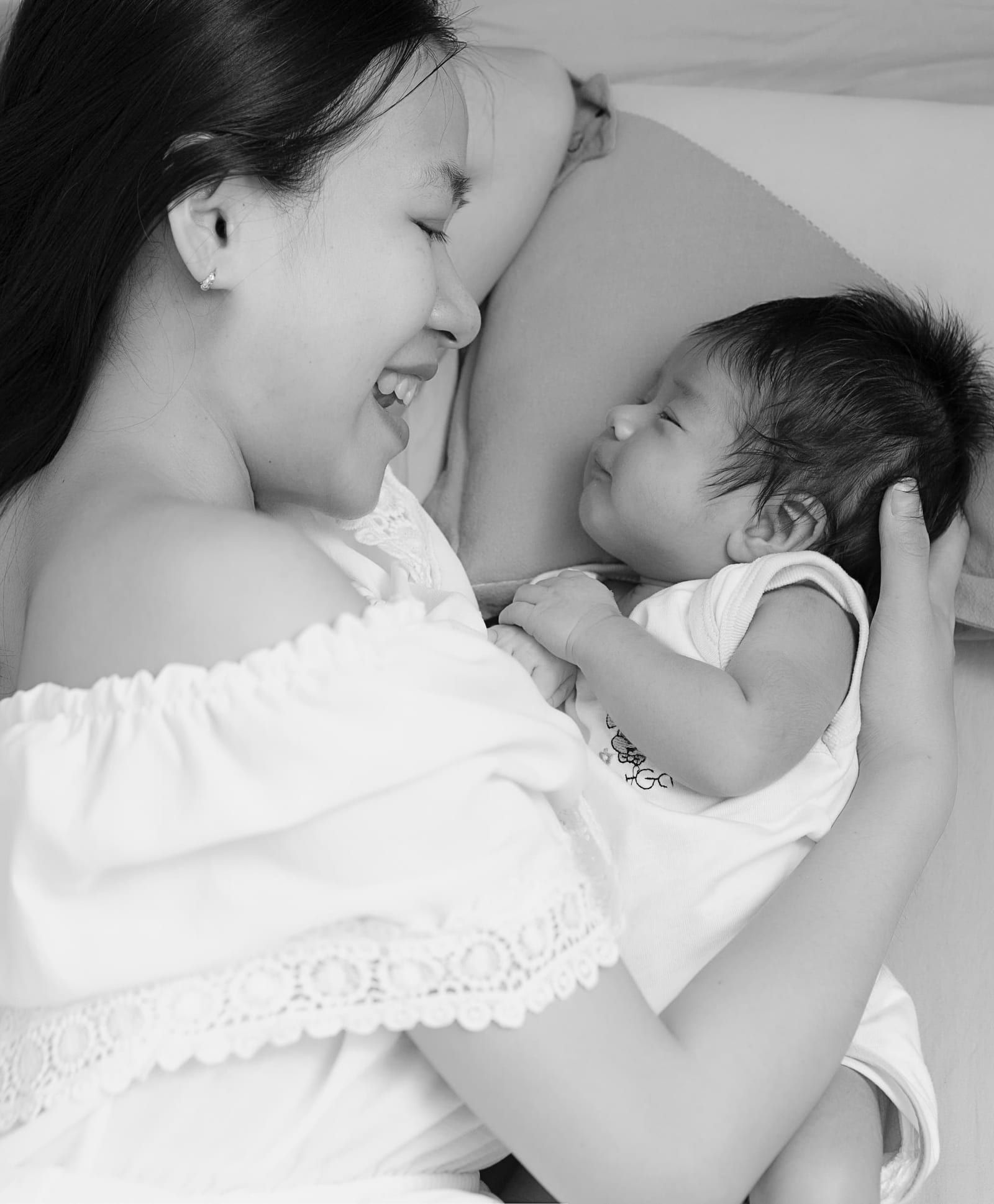 Mother With Cute Son Lying Bed Home (1)